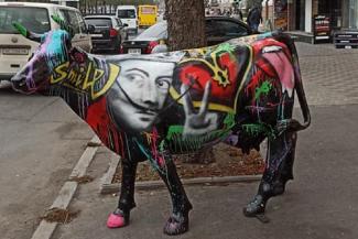 корова