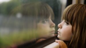 girl_face_sad_brown_window_glass_54552_1366x768-800x445